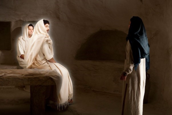 A scene of the woman visiting the tomb of Jesus at his ressurection. Two angels are seated on the tomb looking at the woman.